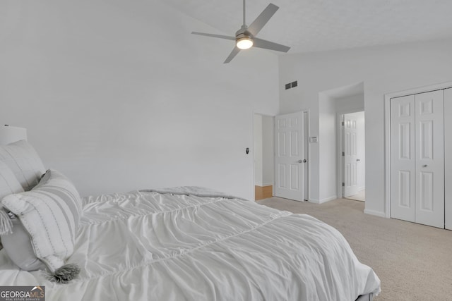 bedroom with baseboards, visible vents, high vaulted ceiling, ceiling fan, and carpet flooring