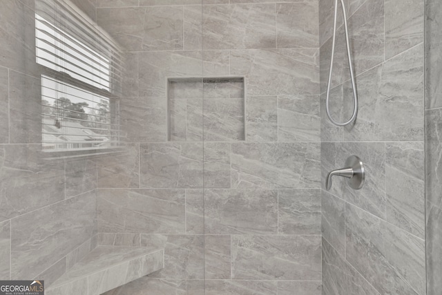 full bathroom featuring tiled shower