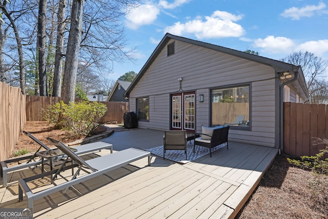 wooden deck featuring french doors and a fenced backyard