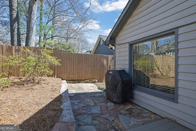 view of patio / terrace with a grill and fence