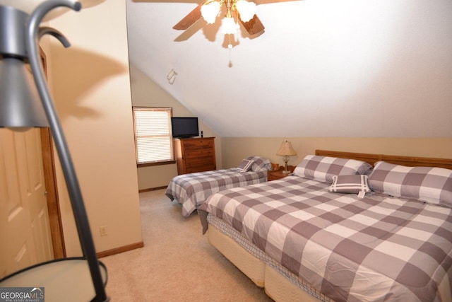 bedroom featuring a ceiling fan, lofted ceiling, light colored carpet, and baseboards