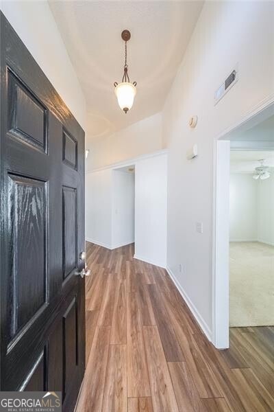 foyer with visible vents, baseboards, and wood finished floors