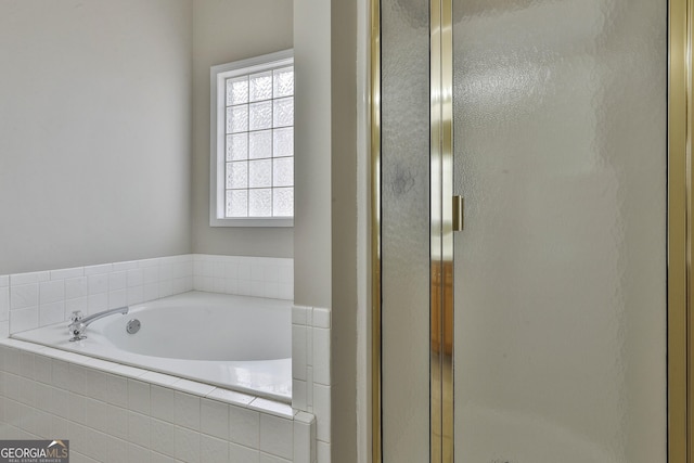 full bathroom featuring a bath and a stall shower