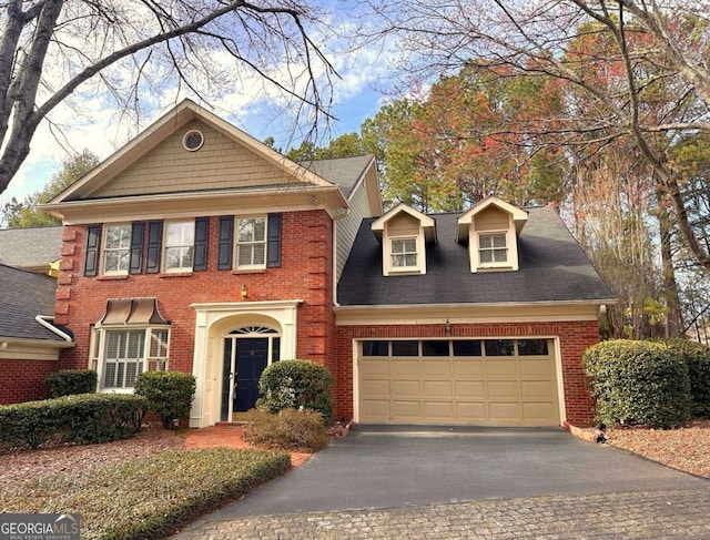 view of front of house with a garage, brick siding, and driveway