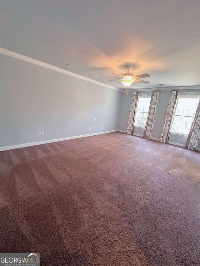 carpeted empty room featuring a ceiling fan, baseboards, and ornamental molding