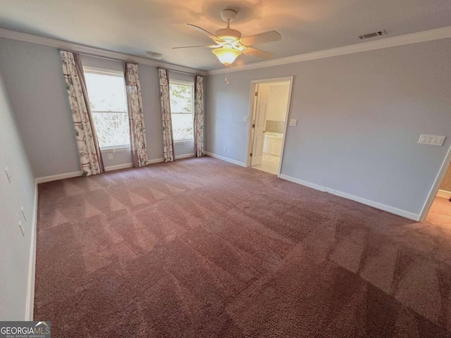 spare room featuring visible vents, crown molding, ceiling fan, baseboards, and carpet