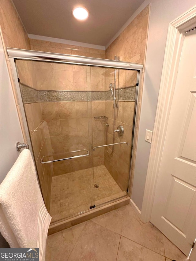 full bathroom with tile patterned floors and a stall shower