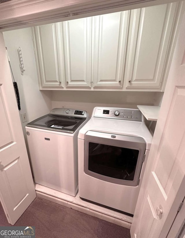 washroom with cabinet space and washing machine and clothes dryer