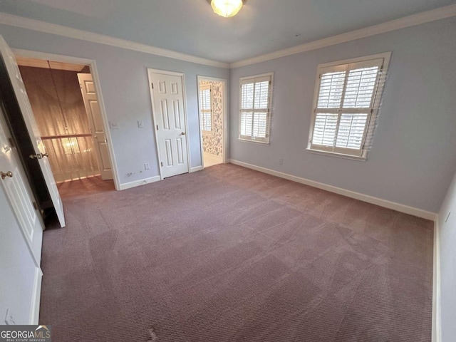 unfurnished bedroom with carpet floors, baseboards, and ornamental molding