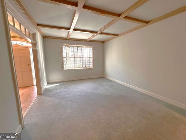 empty room featuring baseboards, coffered ceiling, and carpet flooring