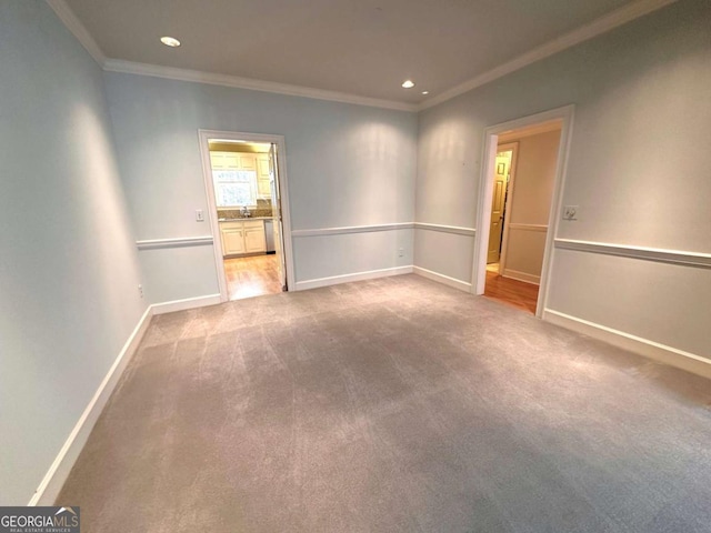 unfurnished room with carpet, recessed lighting, baseboards, and ornamental molding