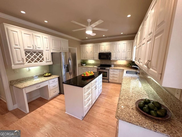 kitchen with ornamental molding, a kitchen island, appliances with stainless steel finishes, and a sink