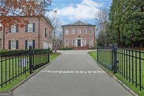 view of gate with a fenced front yard and a yard