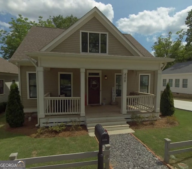 view of front of property featuring covered porch and a shingled roof