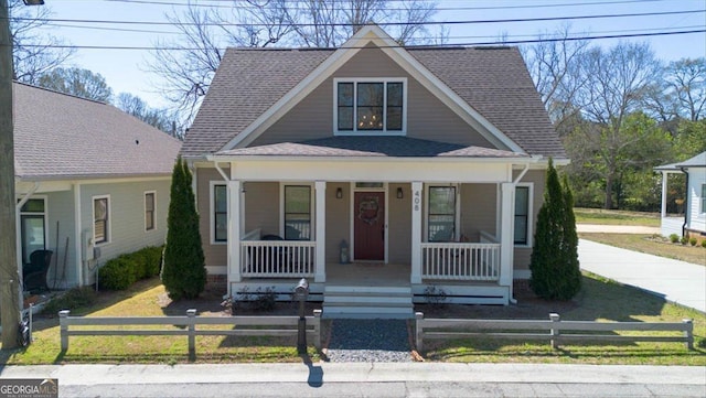 408 Davis St, Monroe, GA 30655 - view of front facade with a porch, a shingled roof, and a fenced front yard