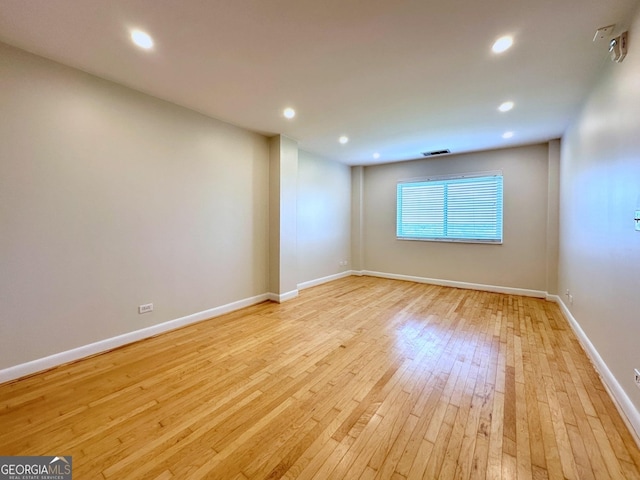 spare room with recessed lighting, baseboards, and light wood finished floors