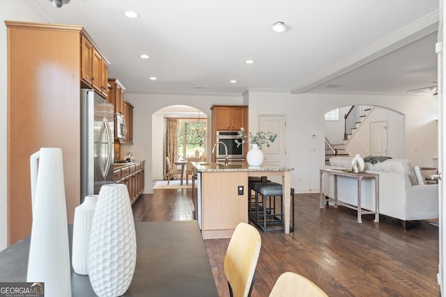 dining space featuring recessed lighting, arched walkways, stairs, dark wood-type flooring, and crown molding