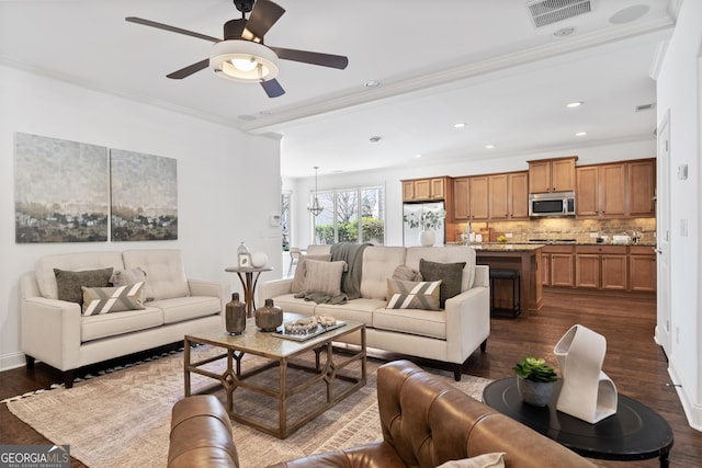 living area with visible vents, ornamental molding, recessed lighting, dark wood-style floors, and a ceiling fan