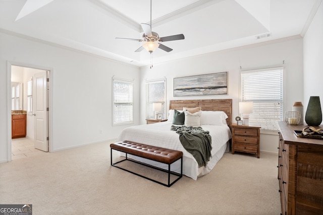 bedroom featuring a tray ceiling, crown molding, light colored carpet, and baseboards