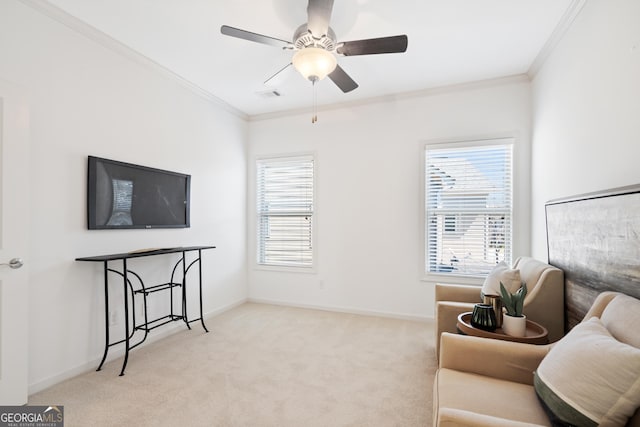 sitting room with crown molding, carpet, baseboards, and ceiling fan