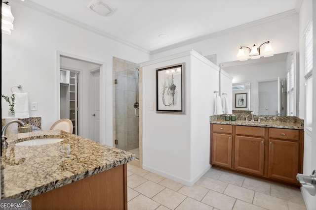 full bathroom featuring crown molding, a stall shower, and a sink