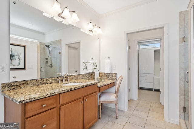 full bathroom with vanity, ornamental molding, a shower stall, and tile patterned flooring