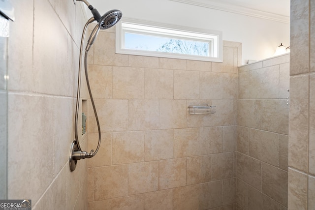 interior details with tiled shower and crown molding