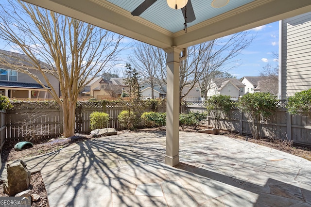 view of patio featuring a ceiling fan, a residential view, and fence private yard