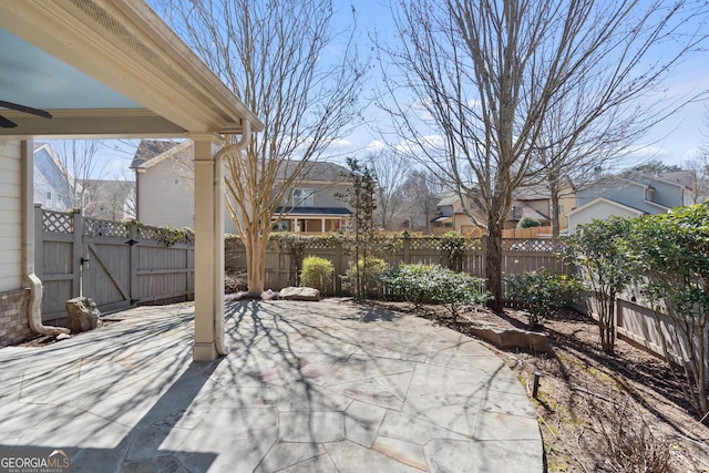 view of patio / terrace featuring a fenced backyard, a ceiling fan, and a gate