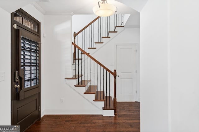 entrance foyer featuring wood finished floors, stairs, baseboards, and ornamental molding