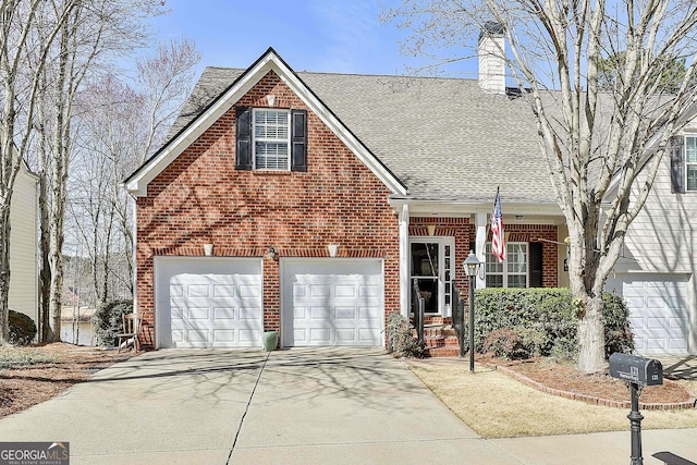 view of front of house with concrete driveway, an attached garage, a shingled roof, brick siding, and a chimney