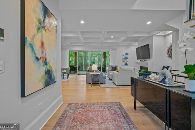 living room featuring beam ceiling, recessed lighting, a fireplace, wood finished floors, and coffered ceiling