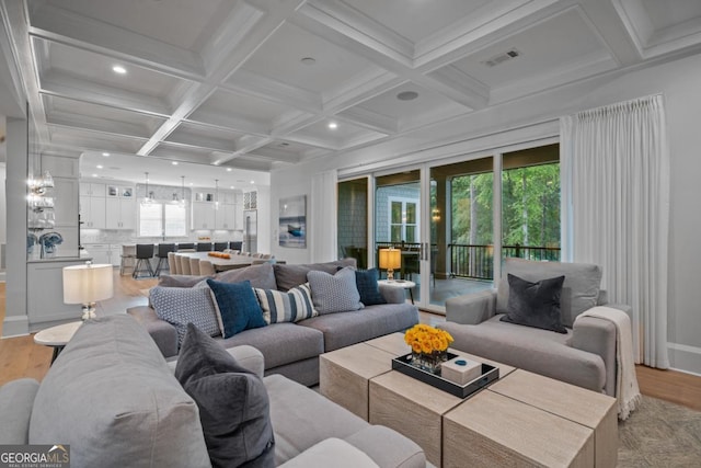 living area featuring light wood-type flooring, visible vents, beamed ceiling, coffered ceiling, and recessed lighting