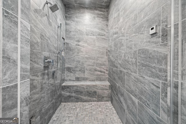 bathroom with a tile shower