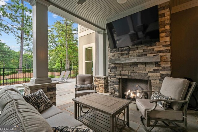 view of patio with an outdoor living space with a fire pit, exterior kitchen, fence, and grilling area