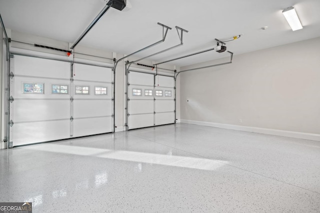 garage featuring baseboards and a garage door opener