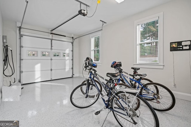 garage with a garage door opener and baseboards