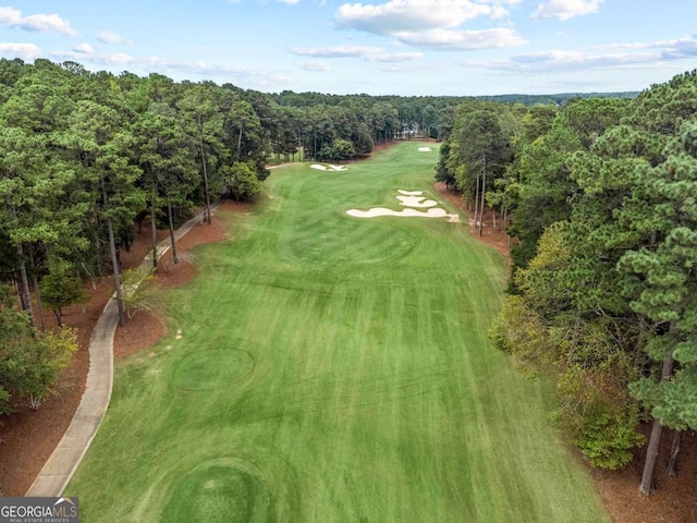 bird's eye view with a view of trees and view of golf course