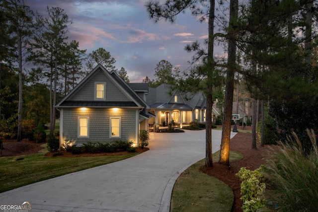 view of front of house with a lawn and concrete driveway