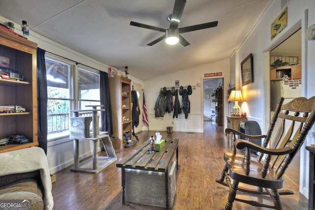 sitting room featuring ceiling fan, baseboards, lofted ceiling, and wood finished floors