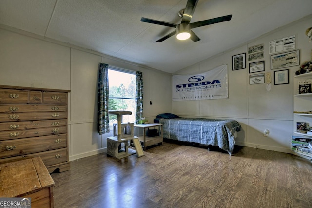 bedroom with a textured ceiling, wood finished floors, a ceiling fan, and vaulted ceiling