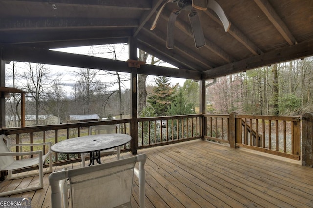 wooden terrace with a view of trees