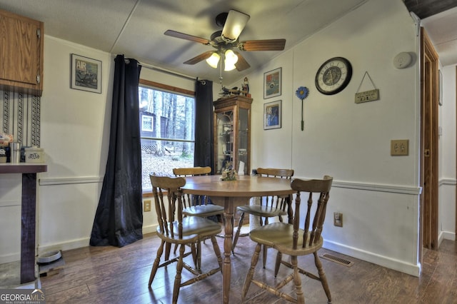 dining space featuring visible vents, baseboards, dark wood-type flooring, and ceiling fan