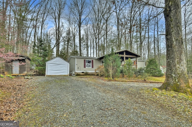 view of front of house featuring crawl space, a storage unit, and an outbuilding