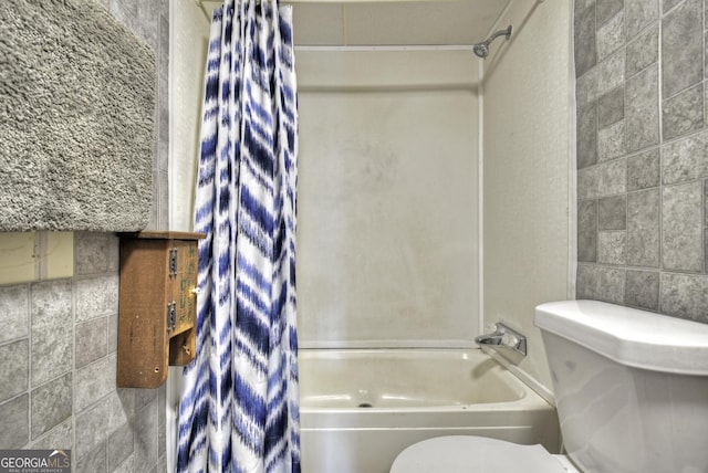 full bathroom featuring tile walls, toilet, and shower / bath combo with shower curtain