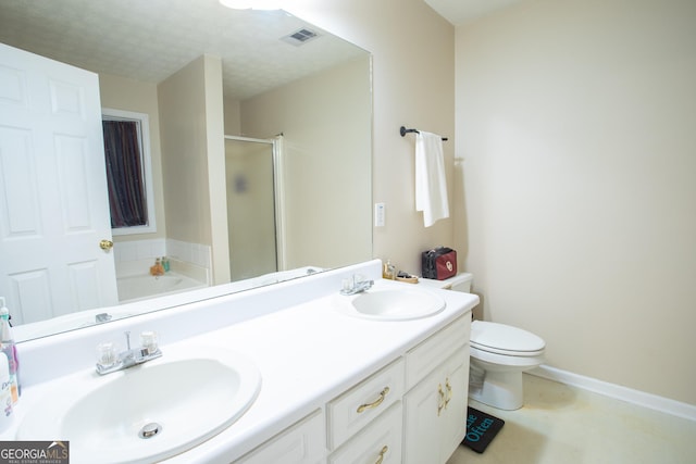 full bath with double vanity, toilet, a stall shower, and a sink