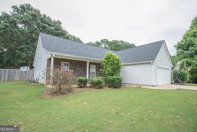 ranch-style house featuring a front yard, fence, driveway, and a shingled roof