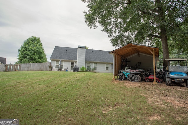 back of property featuring a lawn, fence, and a chimney