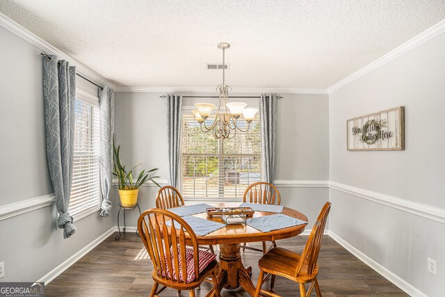 dining room featuring dark wood finished floors, visible vents, baseboards, and an inviting chandelier