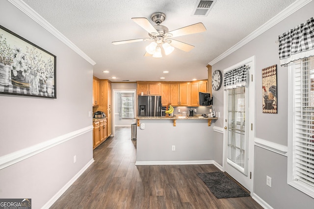 kitchen featuring visible vents, dark wood-type flooring, stainless steel fridge with ice dispenser, ornamental molding, and a peninsula